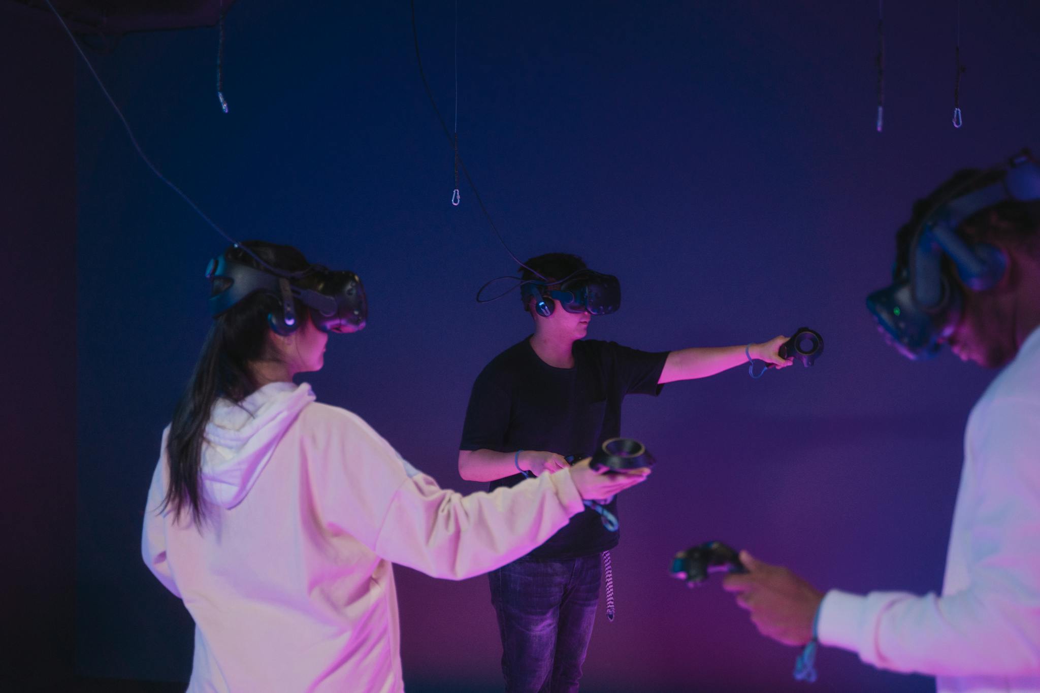 A group of young adults engaging in immersive virtual reality gaming indoors.